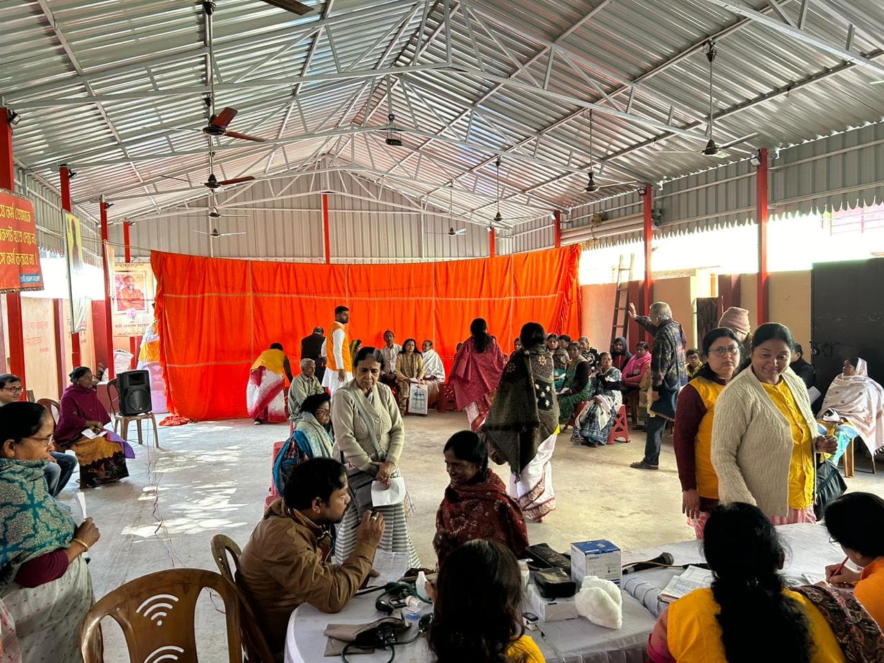 A medical camp: people gathered as doctors and volunteers attend to them