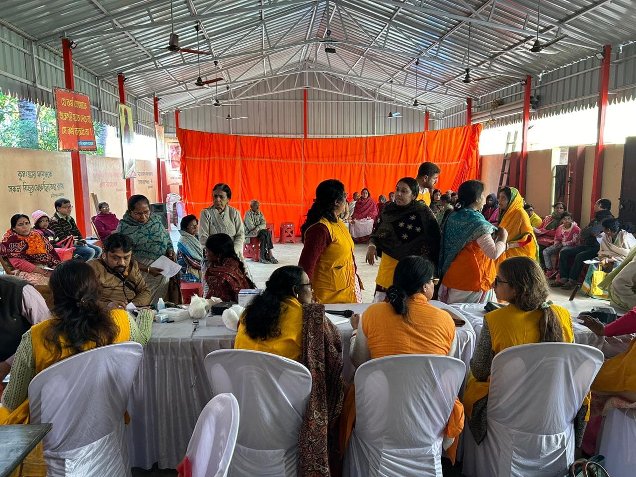 A medical camp: people gathered as doctors and volunteers attend to them