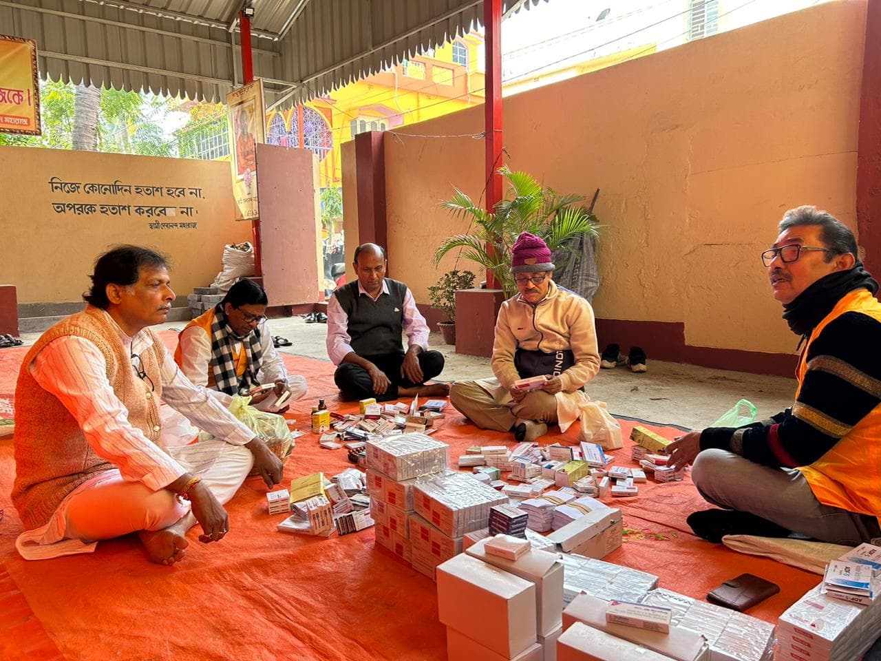A medical camp: people gathered as doctors and volunteers attend to them