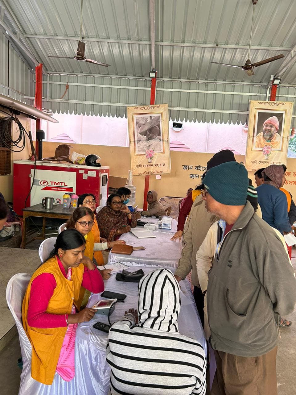 A medical camp: people gathered as doctors and volunteers attend to them