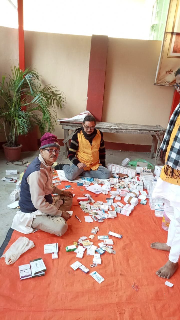 A medical camp: people gathered as doctors and volunteers attend to them