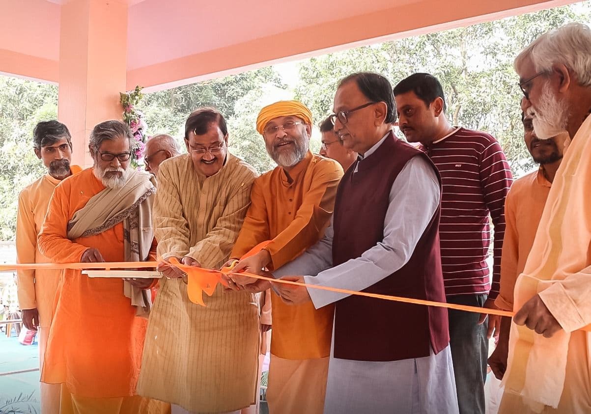 Monks and guests cutting a ribbon at an entrance