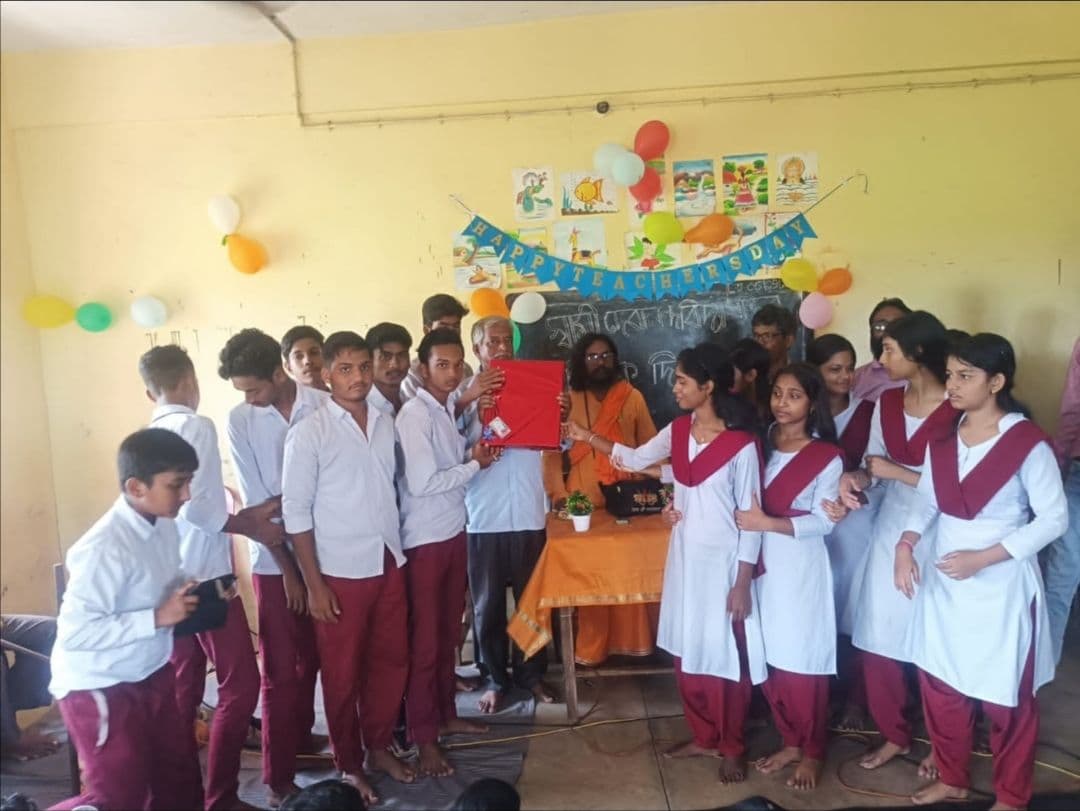Students in uniform standing at the front of a classroom decorated with balloons and bunting