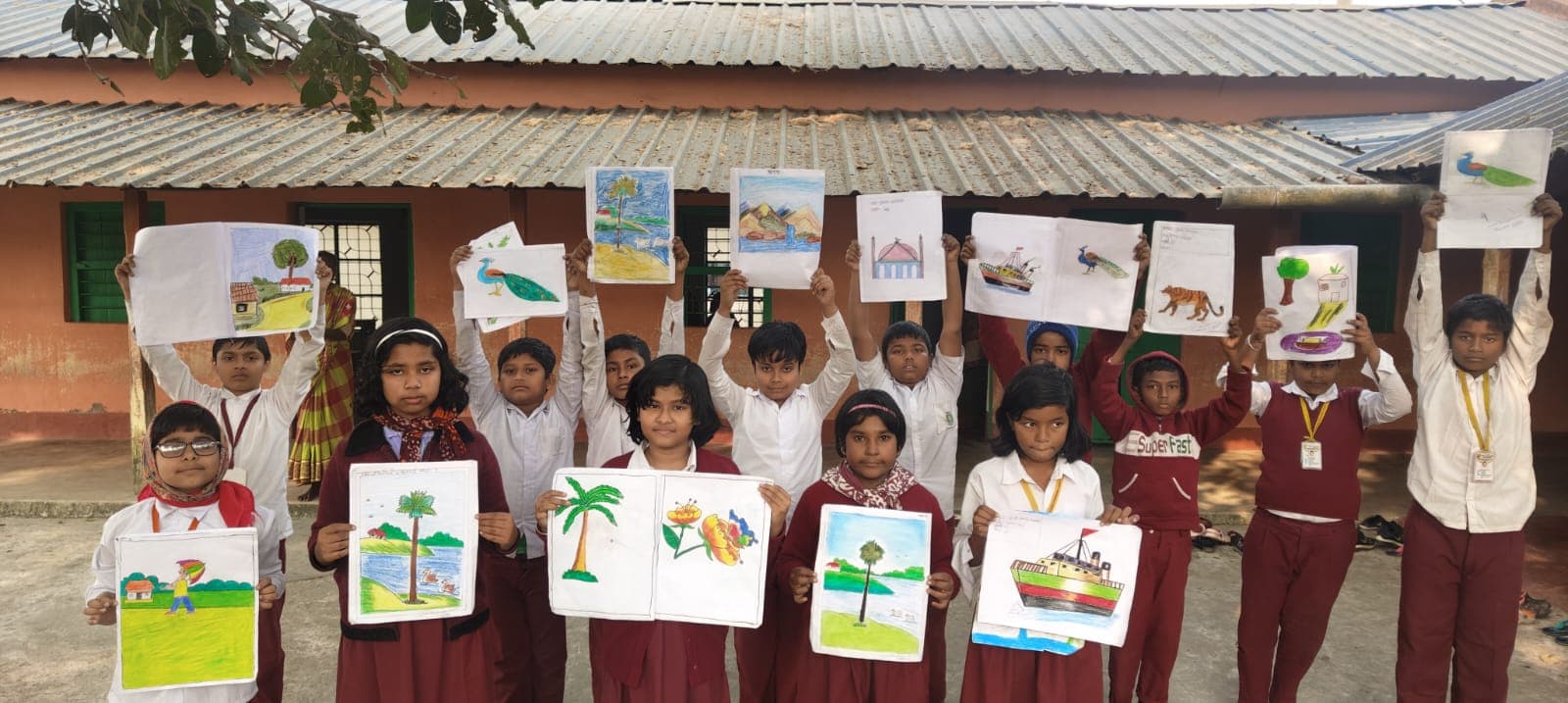 Students in uniform holding up their paintings in front of a tin-roofed building